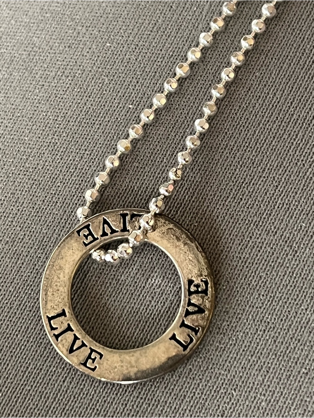 NWT infinity circle imprinted with live. Layered in sterling silver.